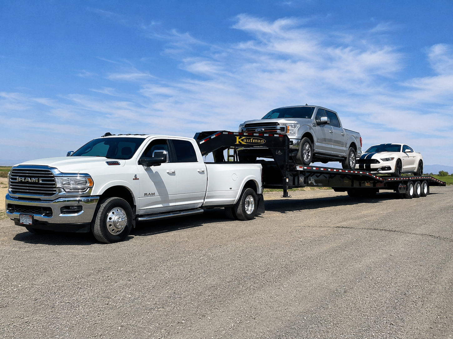 Dually truck pulling an enclosed car-hauler with vehicles inside